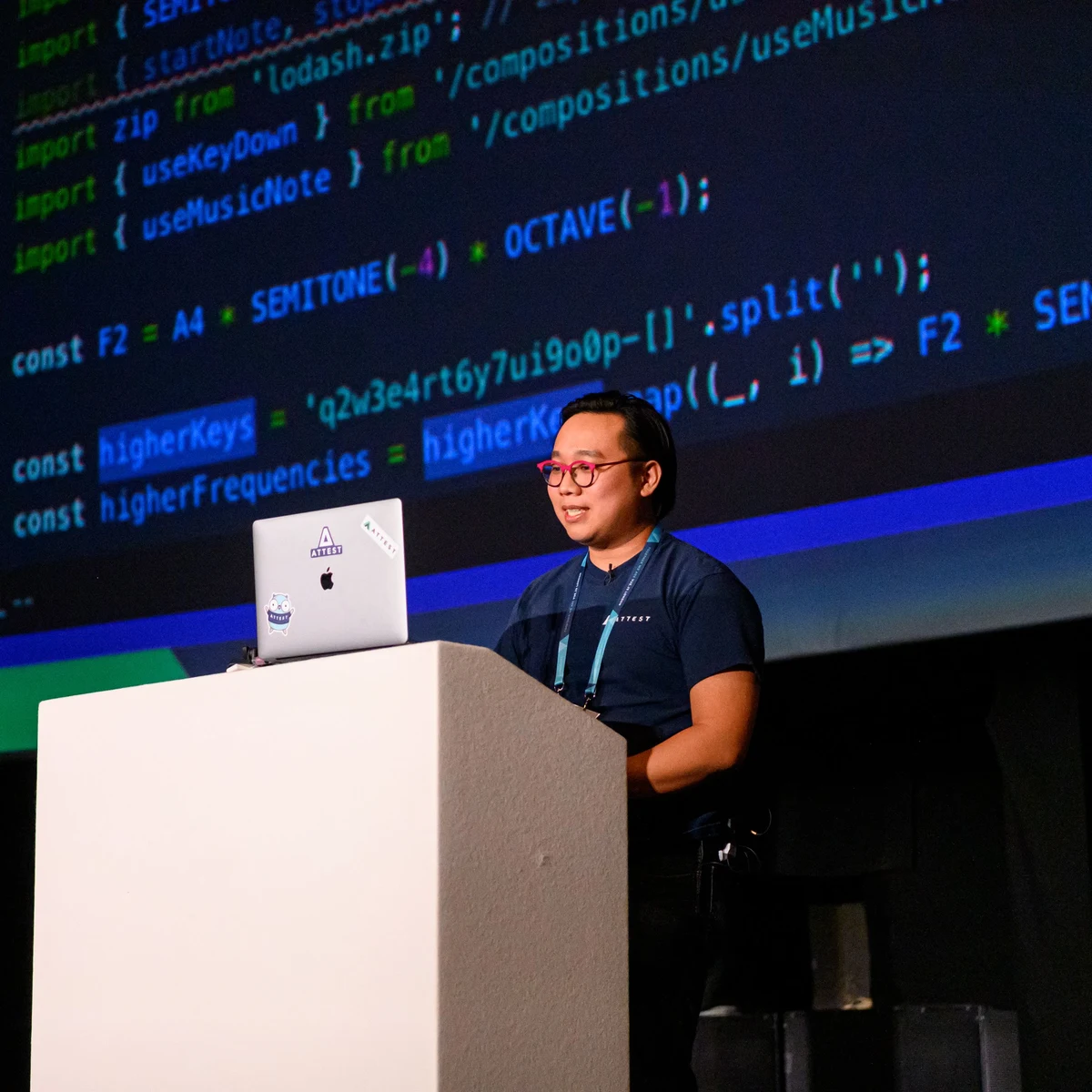 Jason on stage at Vue.js London, with a code projection behind him